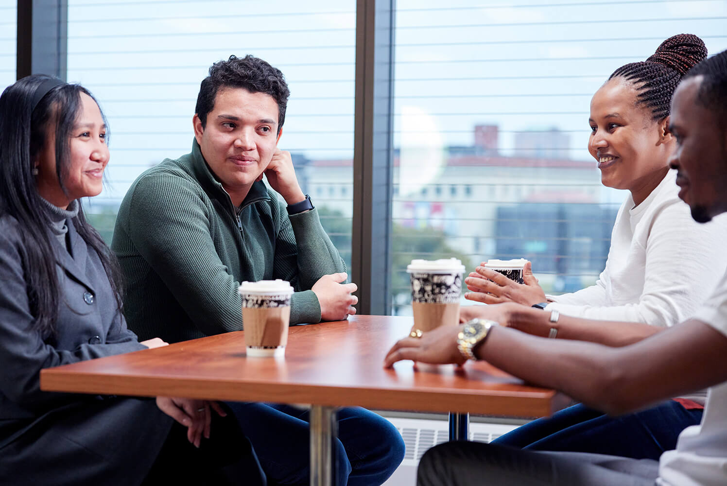 Group drinking coffee with a view of the city