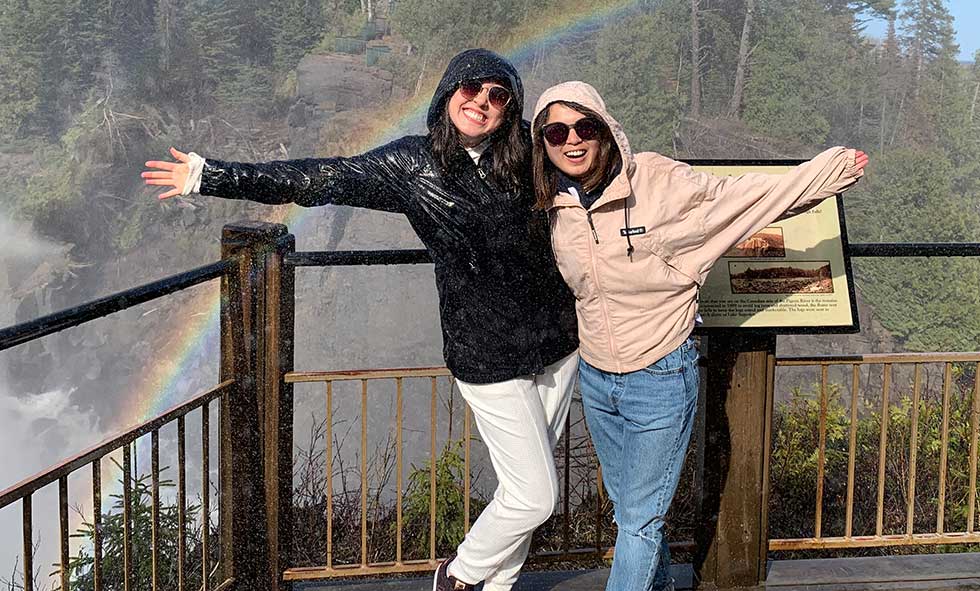 Xiulin Wang in front of waterfall with friend